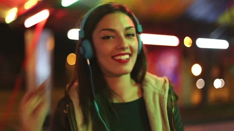 Beautiful woman dancing to the rhythm of music with headphones Stock Footage 59556060