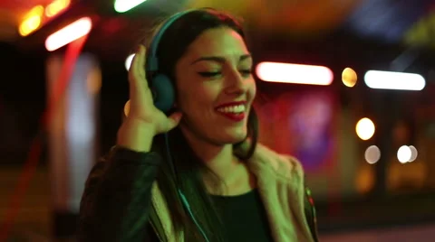 Beautiful woman dancing to the rhythm of music with headphones Stock Footage 59556066