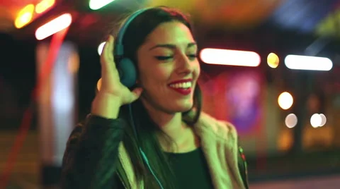 Beautiful woman dancing to the rhythm of music with headphones Stock Footage 59556067