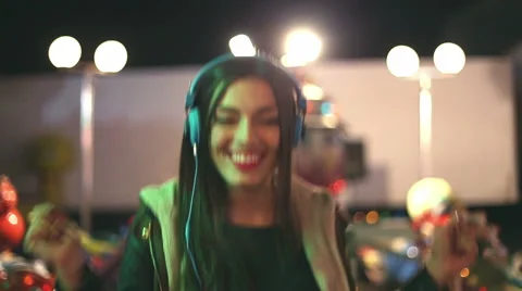 Beautiful woman dancing to the rhythm of music with headphones Stock Footage 59556105