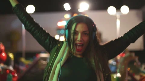 Beautiful woman dancing to the rhythm of music with headphones Stock Footage 59556108