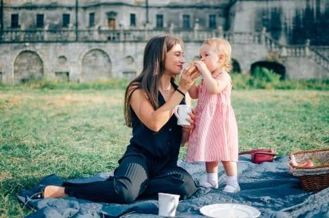 Beautiful woman with daughter at picnic Stock Photos