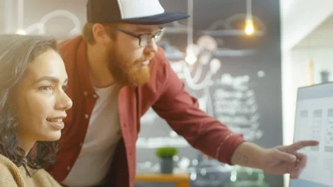 Beautiful Woman Developer Uses Personal Computer and Talks With a Programer. Stock Footage 82900368