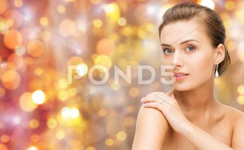 Beautiful woman with diamond ring and earrings Stock Photos