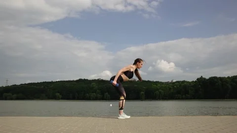 Beautiful woman doing exercise outside Stock Footage 132882995