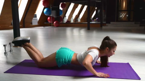 Beautiful woman doing push ups in the gym with a ball Stock-Footage 63203465