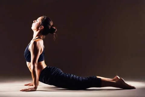 Beautiful woman is doing yoga asana Stock Photos