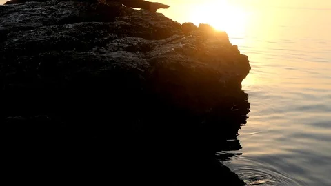 Beautiful woman doingright leg split on the rocks Stock Footage 106475952