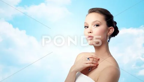Beautiful woman with earring, ring and pendant Stock Photos