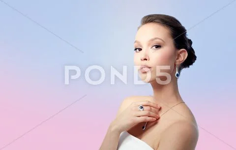 Beautiful woman with earring, ring and pendant Stock Photos