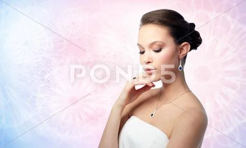 Beautiful woman with earring, ring and pendant Stock Photos