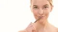 The beautiful woman with a eyebrow pencil flirts on the white background 4k or 4k+ Resolution