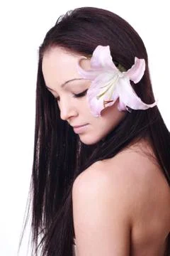 Beautiful woman with eyes closed and orchids in her hair Stock Photos