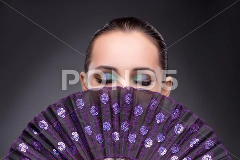 Beautiful Woman With Fan In Fashion Concept