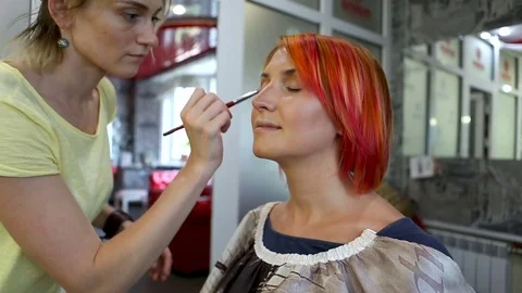 Beautiful woman getting professional make-up with brush. Stock Footage