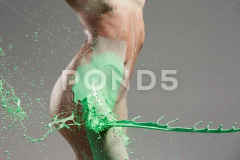 The beautiful woman with green liquid paint over her body Stock Photos