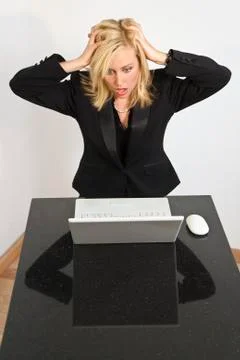 Beautiful woman having computer problems Stock Photos