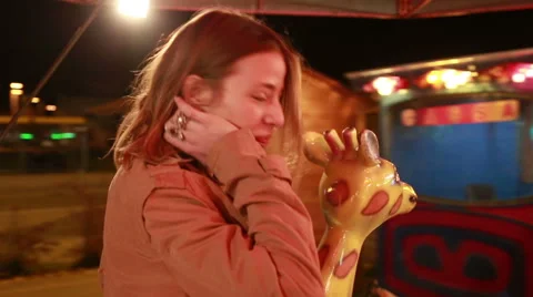 Beautiful woman having fun riding carousel in amusement park Stock Footage 59556214