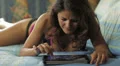 beautiful woman is having fun with the tablet at the hotel HD Footage