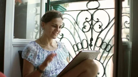 Beautiful woman having a videocall on modern tablet Stock Footage