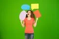 The beautiful woman hold a dialog signs on the green background Photo