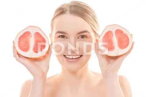 The beautiful woman holding a grapefruit on the white background Stock Photos