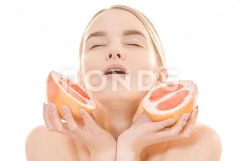 The beautiful woman holding a grapefruit on the white background Stock Photos
