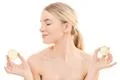 The beautiful woman holding a lemon on the white background Photo