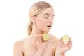 The beautiful woman holding a lime on the white background Photo