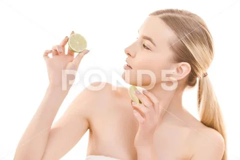The beautiful woman holding a lime on the white background Stock Photos