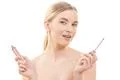 The beautiful woman holding a lip gloss on the white background Photo