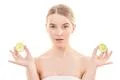 The beautiful woman holding two halves of a lime on the white background Photo