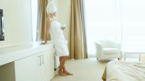 The beautiful woman in a hotel room drinking coffee Stock Footage