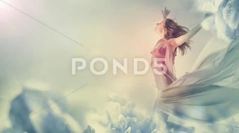 Beautiful woman jumping on a giant flower Stock Photos