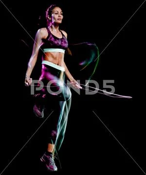 Beautiful woman jumping rope fitness exercises isolated black background Stock Photos