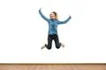 The beautiful woman jumping on the white wall background Photo