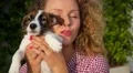 Beautiful Woman Kissing Cute Puppy Outdoors HD Footage