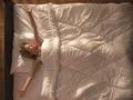The beautiful woman lay on the bed and gesture. View from above Photo