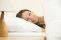 The beautiful woman lay on the bed and smile Photo