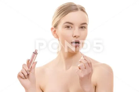 The beautiful woman with a lip gloss on the white background Stock Photos