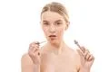 The beautiful woman with a lips gloss on the white background Photo