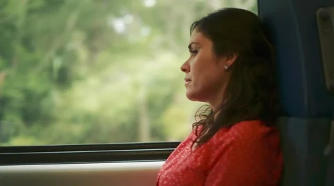Beautiful woman looking pensive inside a train Stock Footage 56242523