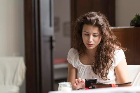 Beautiful woman looking worried on her phone Stock Photos