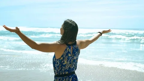 Beautiful woman looks very happy while standing on the beach and relaxing, stead Stock Footage