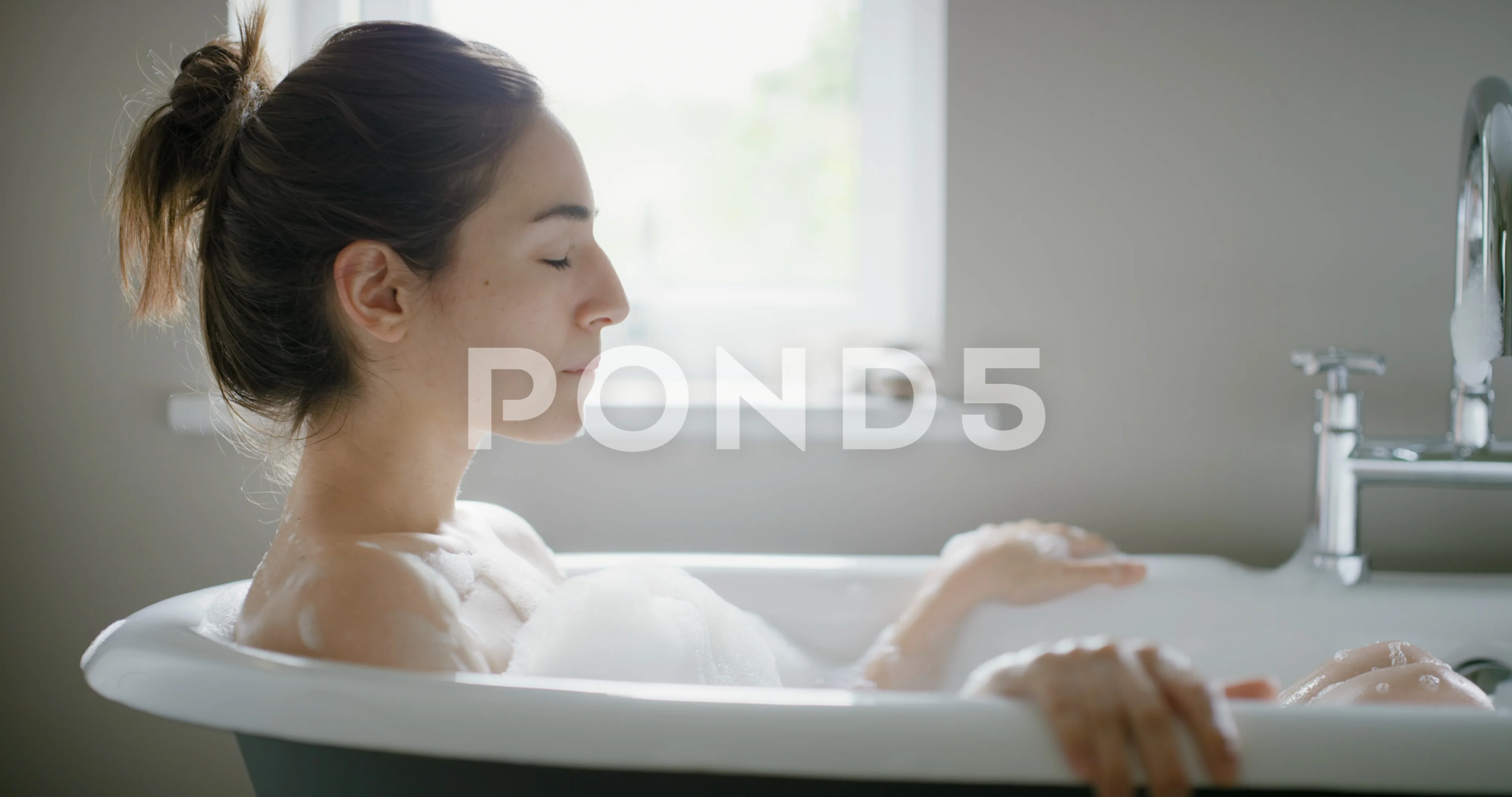 https://images.pond5.com/beautiful-woman-lying-bathtub-enjoying-073365568_prevstill.jpeg