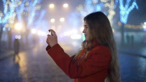 Beautiful woman making a photo with her smartphone on the street slow motion Stock Footage
