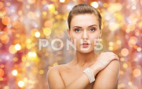 Beautiful woman with pearl earrings and bracelet Stock Photos