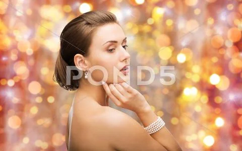 Beautiful woman with pearl earrings and bracelet Stock Photos