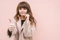 The beautiful woman phone and gesture on the pink wall background Photo