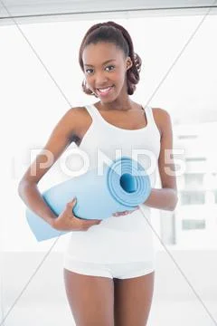 Beautiful woman posing with exercise mat Stock Photos
